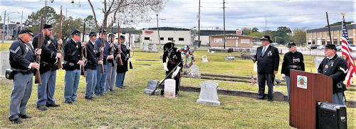 Brother John Schneider of the Ellsworth Camp of Dallas placing the 'Tools of the Soldier' at the headstone during the ceremony.